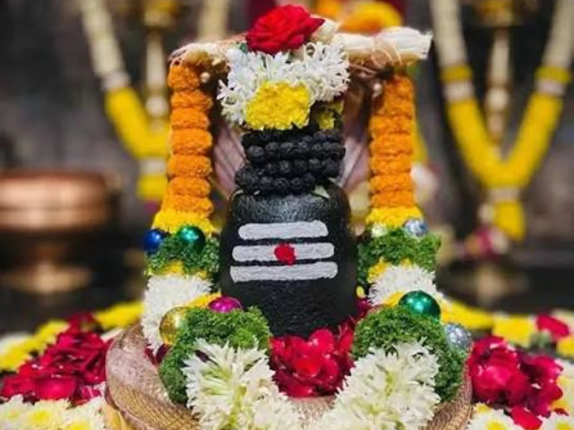 Shivling decorated with marigold and rose garlands for Shiv puja